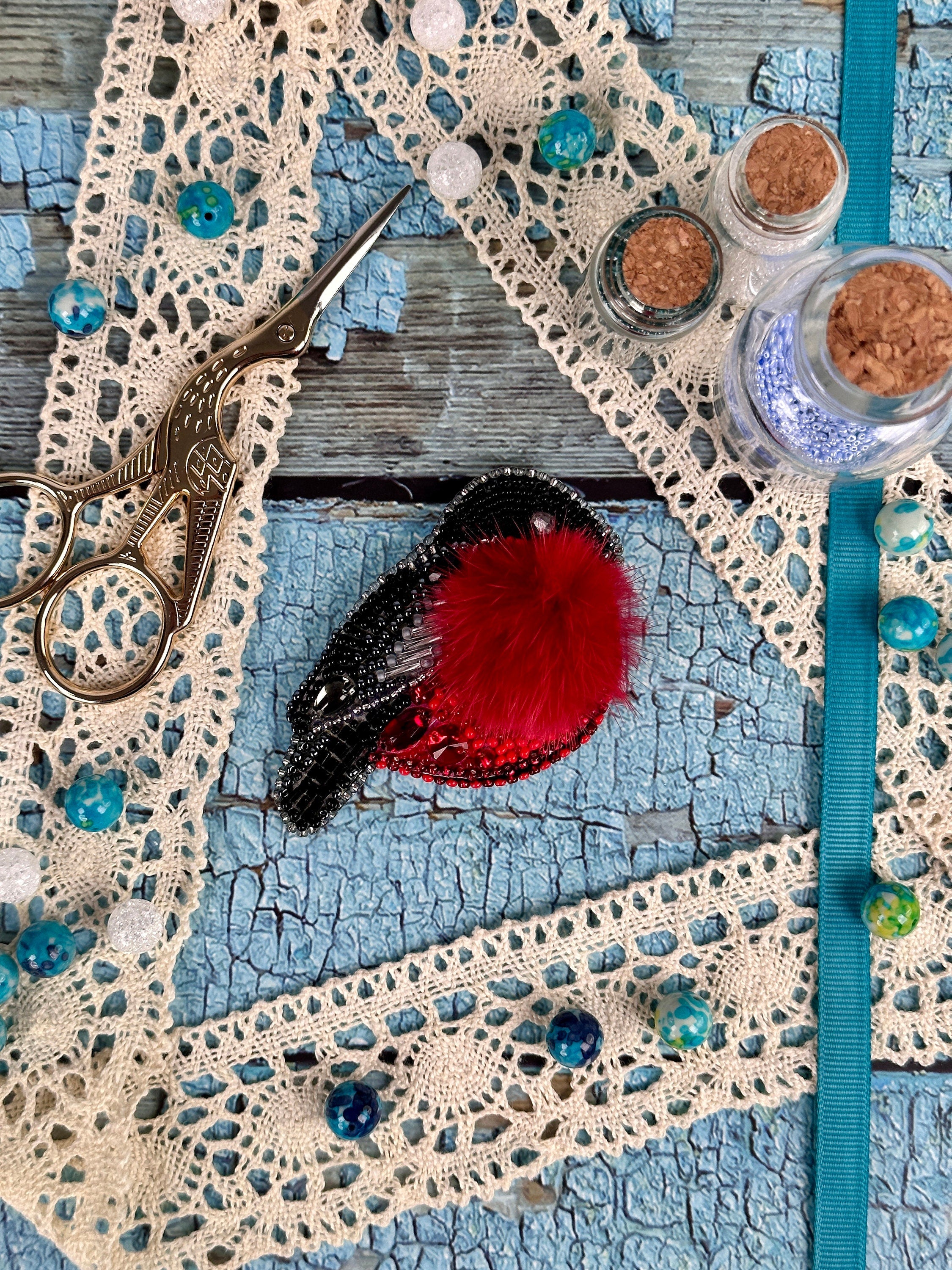 a pair of scissors sitting on top of a piece of lace